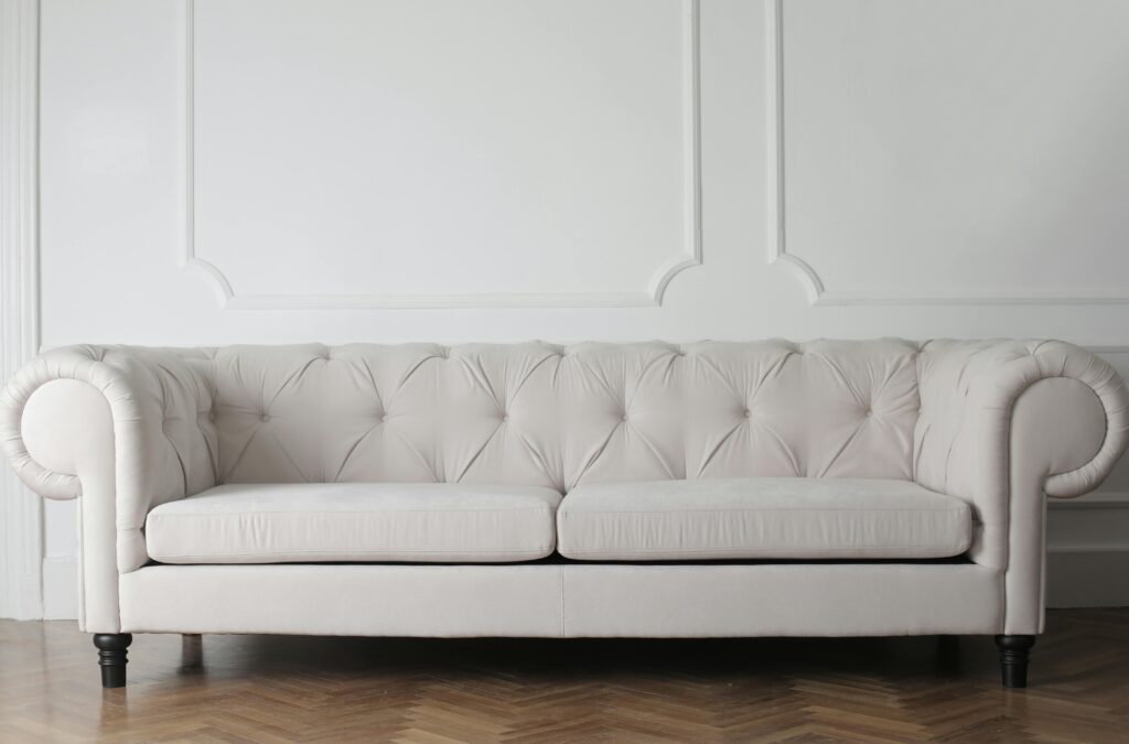 pexels-photo-3757055-3757055 Luxurious white sofa in a modern minimalist interior with wooden flooring.